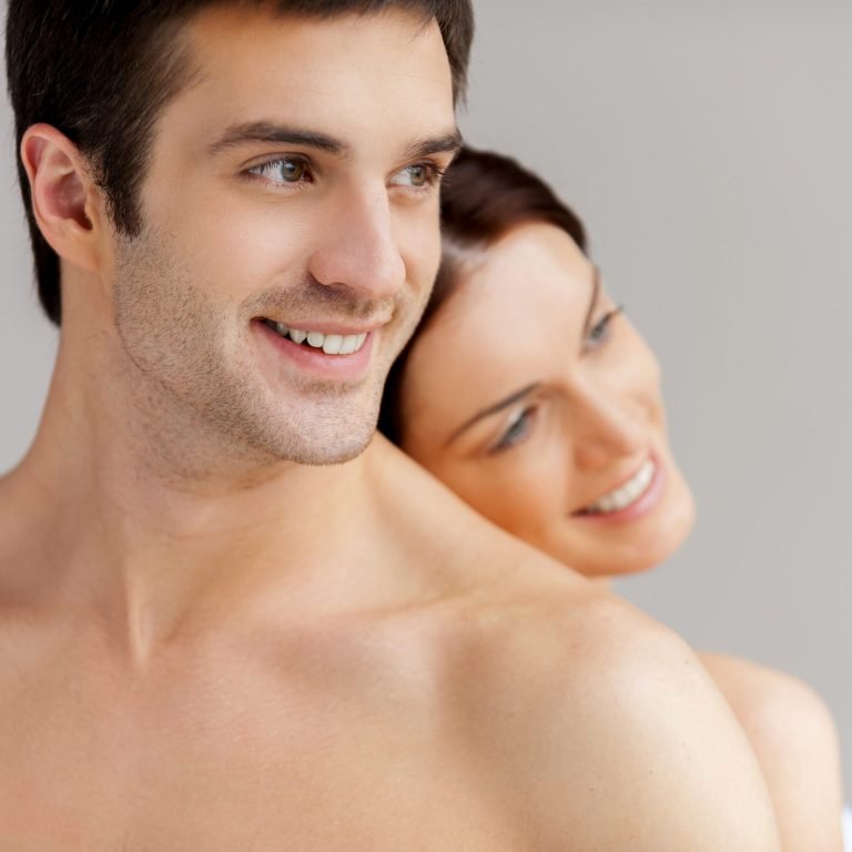 So good to be together. Cheerful young loving couple standing back to back and smiling